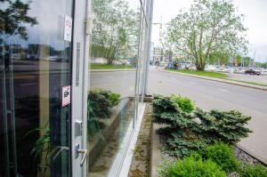 a window of a building with plants outside of it at Harbour Hub Hostel in Tallinn +20 photos