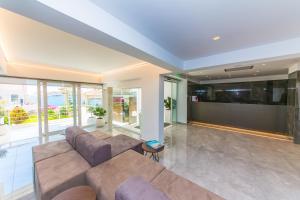 a large living room with couches and a tv at Hotel Agimi in Sarandë