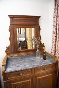 a wooden dresser with a mirror on top of it at B&B Cedavécia in Comèlico Superiore