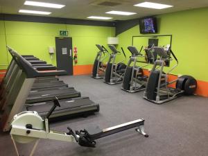 una palestra con diversi tapis roulant e macchinari per il cardio-fitness di Hooton Golf Club a Little Sutton