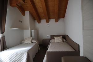 Postel nebo postele na pokoji v ubytování Albergo Del Ponte