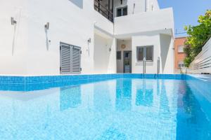 a swimming pool in a villa with blue water at Rotunda Suites in Kalamaki Chanion