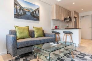 a living room with a couch and a table at C502 Woodstock Quarter in Cape Town