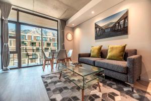 a living room with a couch and a table at C502 Woodstock Quarter in Cape Town
