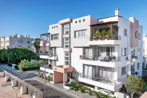 an apartment building with balconies on a street at Rix Palm Apartments in Kyrenia