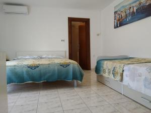 a bedroom with two beds and a doorway at Apartments Vitae in Pula