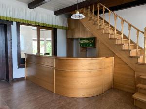 a lobby with a wooden counter and stairs at Shpinat in Odesa