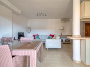 a living room with a table and a couch at Apartment Residencial Roma by Interhome in Jávea