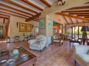 a large living room with white furniture and wooden ceilings at Villa Villa Adelfa by Interhome in Jávea