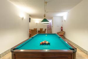 a pool table in the middle of a living room at Vila Channa - Adults Only in Albufeira