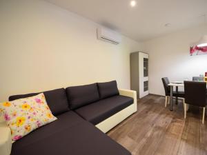 a living room with a couch and a table at Apartment Sandra by Interhome in Matulji