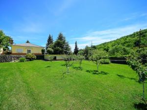 a yard with trees and a house in the background at Apartment Sandra by Interhome in Matulji