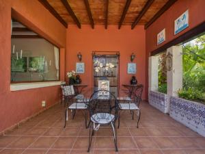 a patio with chairs and a table on a orange wall at Villa Villa Adelfa by Interhome in Jávea