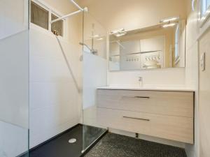 ein Bad mit einem Waschbecken und einem Spiegel in der Unterkunft Holiday Home Ile de france by Interhome in Labenne