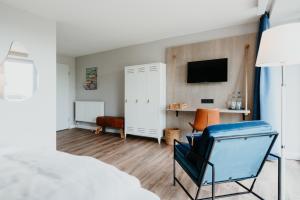 - une chambre avec un lit et une télévision murale dans l'établissement Siel59 Hotel & Restaurant, à Ockholm