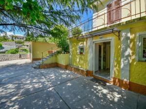 an empty street in front of a yellow building at Apartment Sandra by Interhome in Matulji +12 photos