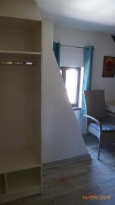 a room with a stairway with a chair and a window at Penzion Sklář in Nový Bor