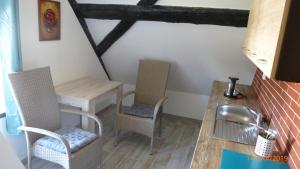 a kitchen with two chairs and a table and a table at Penzion Sklář in Nový Bor