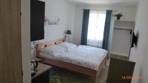 a small bedroom with a bed and a window at Penzion Sklář in Nový Bor