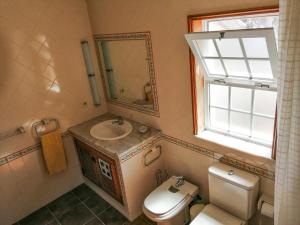 a bathroom with a toilet and a sink and a mirror at Casa da Balseira in Aveiro +24 photos
