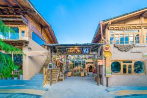 a group of buildings with tables and chairs at Home Away From Home in Shangri-La