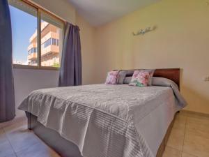 a bedroom with a large bed with a window at Apartment Calpe Pueblo by Interhome in Calpe +9 photos