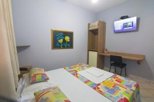 En eller flere senge i et værelse på Hotel Igapó