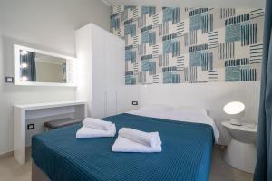 a bedroom with a bed with two towels on it at Sealine Apartments A2 in Tivat +25 photos