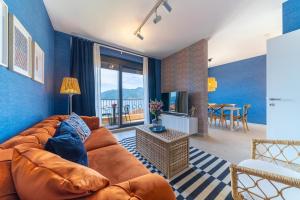 a living room with a couch and a table at Sealine Apartments A2 in Tivat