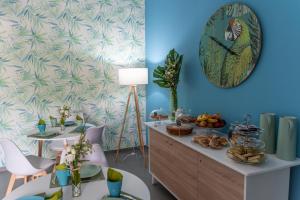 a room with a table with food and a clock on the wall at Me&Sea B&B in San Nicola Arcella