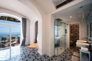 a bathroom with a shower and a glass shower stall at Hotel Montemare in Positano