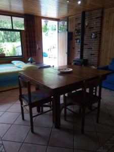 a wooden table and two chairs in a room at Chalet del Laghetto in Chiusa di Pesio
