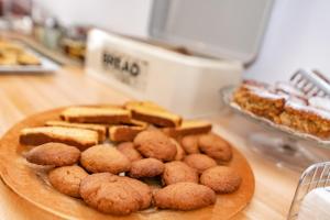 a plate of cookies and other pastries on a counter at Porto Bello Tinos in Agios Ioannis