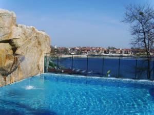 a large swimming pool with a view of the water at Selena Hotel in Sozopol