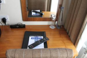a table with a book and two remote controls on it at Mackays Hotel in Wick