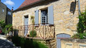a stone house with a balcony and a window at Maison de la Combe in Domme +76 photos