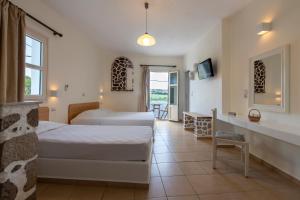 A bed or beds in a room at Filoxenia Apartments