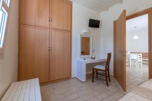 A bed or beds in a room at Filoxenia Apartments