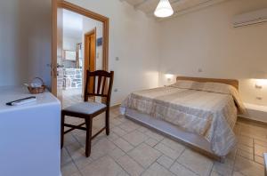 A bed or beds in a room at Filoxenia Apartments
