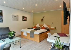 a bedroom with a bed and a living room at Appartements Moselblick in Klotten