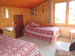 a bedroom with two beds and a window at Chalets Pyrene Mont-Blanc in Chamonix-Mont-Blanc