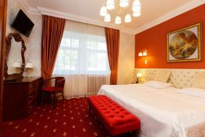 a hotel room with a bed and a chair and a window at Severnaya Hotel in Petrozavodsk