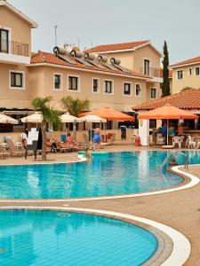 a large swimming pool in front of a hotel at Kyklades Angie Resort in Protaras