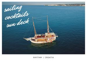 a boat in the water with the words knitting cocktails istg index at Rhythm Floating Hostel - Split in Split