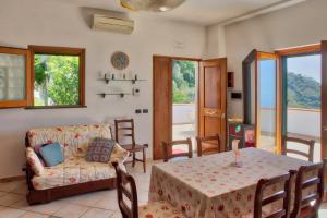 a living room with a table and a couch at "CASALENA" Villa a Furore Amalfi coast con grande terrazzo e vista sul MARE in Furore