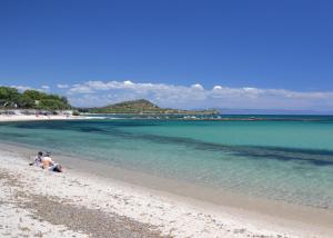 a couple of people sitting on the beach at Villa Elisabetta Apartments in Pula