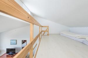 a room with two bunk beds and a staircase at Hotel Hvide Falk in Ilulissat