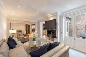 a living room with a couch and a fireplace at Stunning 6-bed house near Harrods in Knightsbridge in London