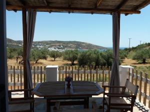 a table and two chairs on a porch with a view at Studios Evdokia in Platis Gialos