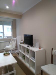 Televízia a/alebo spoločenská miestnosť v ubytovaní Torre Center II